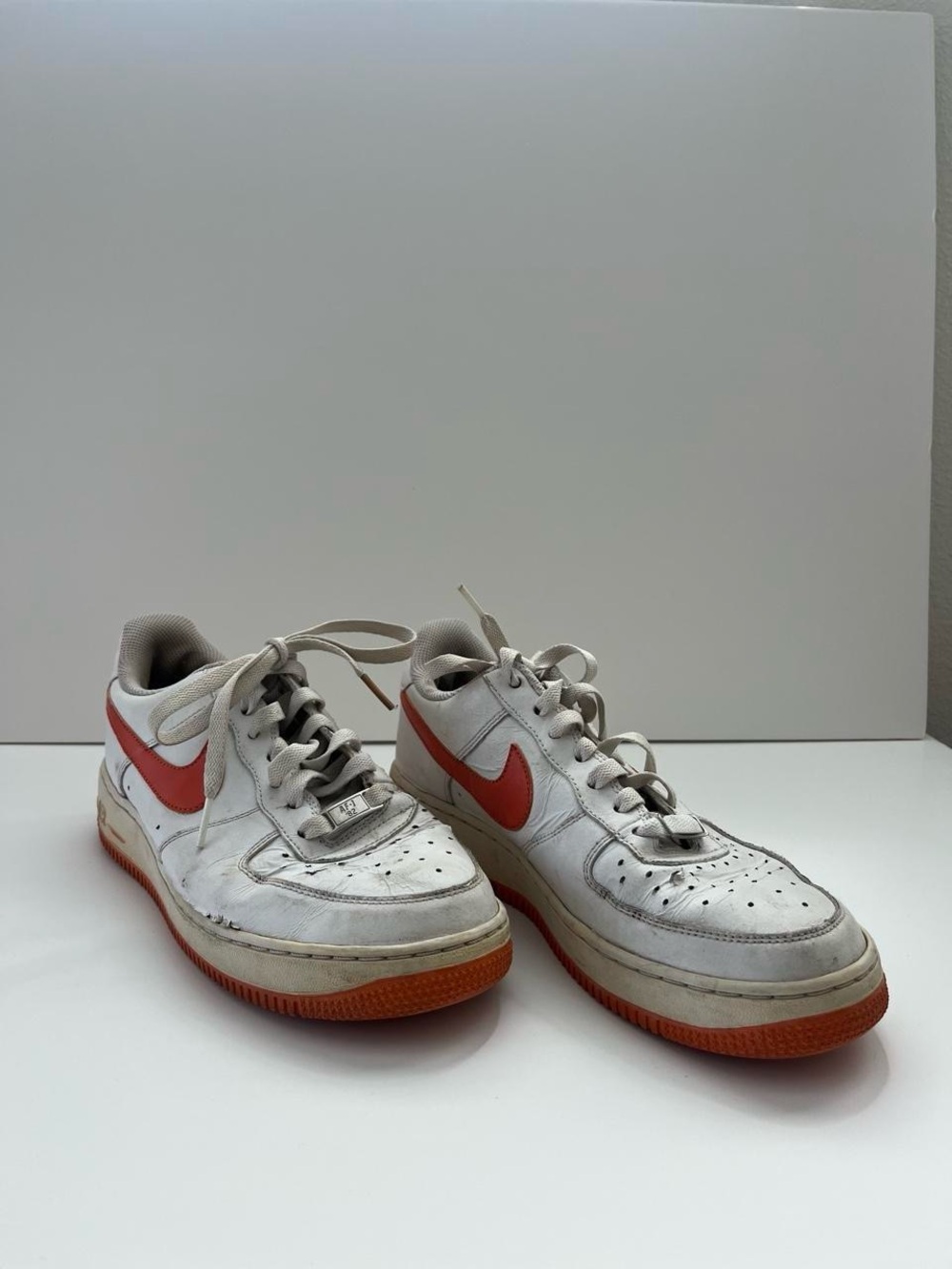 Nike Kids White Sneakers with Orange-Red Swoosh